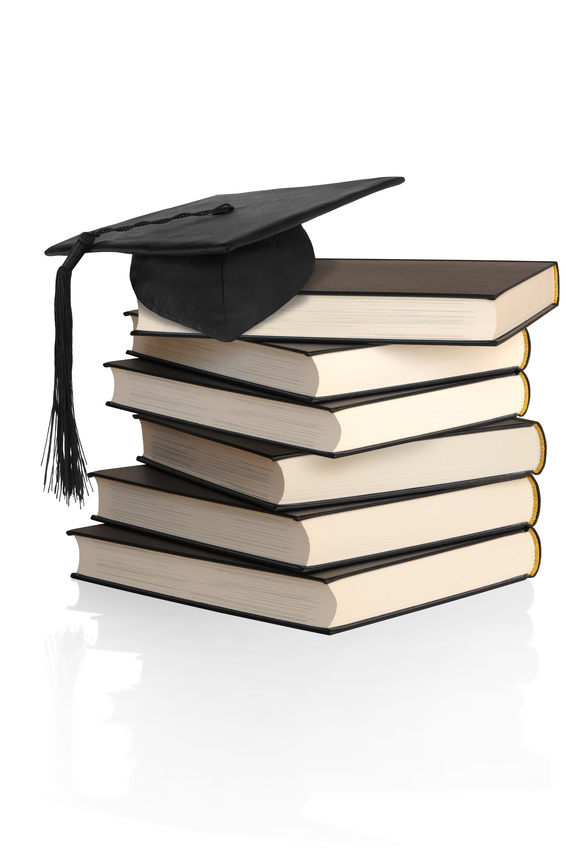Stack of books with academic mortarboard as a symbol for coaching and training